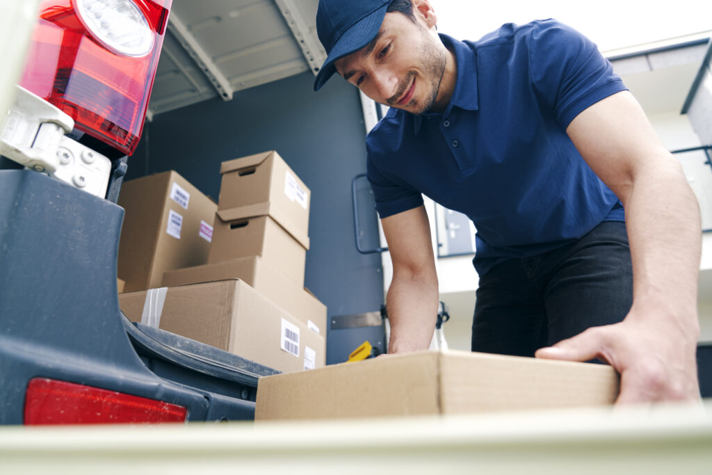 Interstate courier services australia. Courier unloading packages on the hand truck