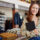 young girl standing fashion store holding laptop