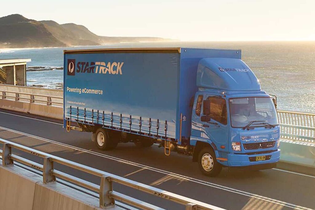Startrack truck on road delivering parcels