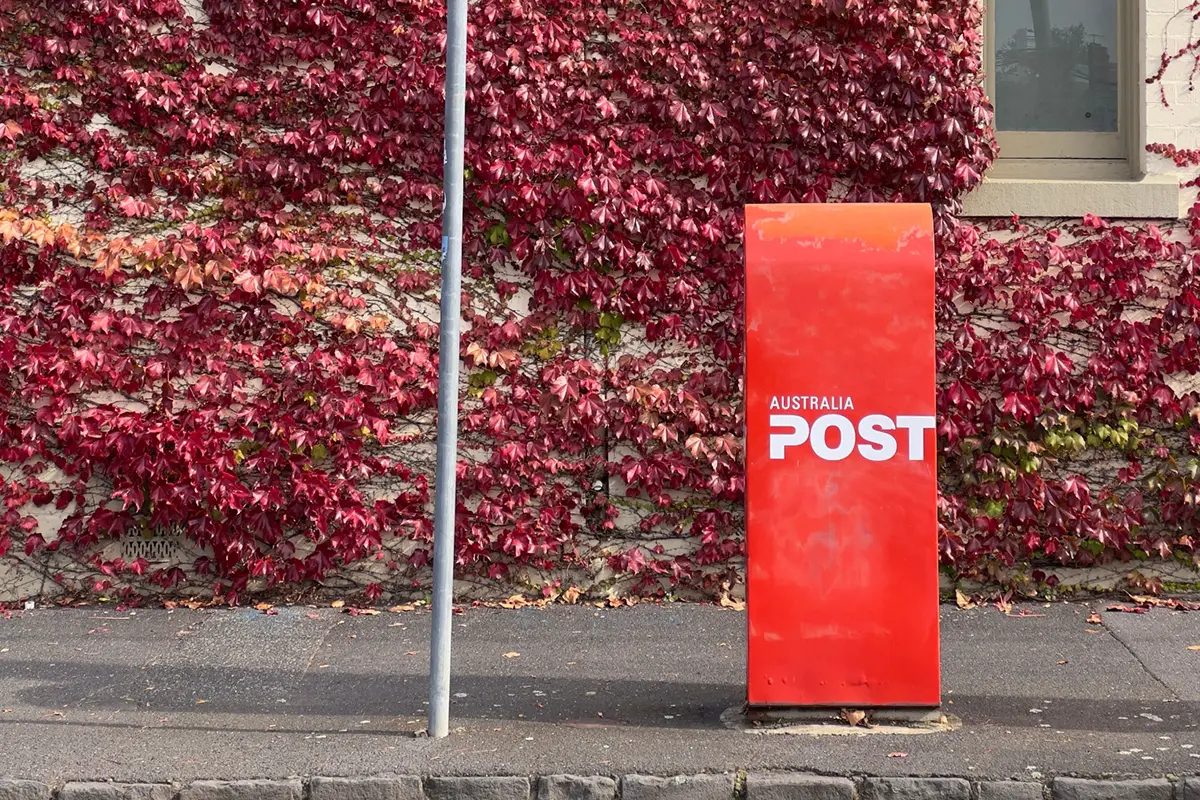 Red Australia post box on the side of a street 
