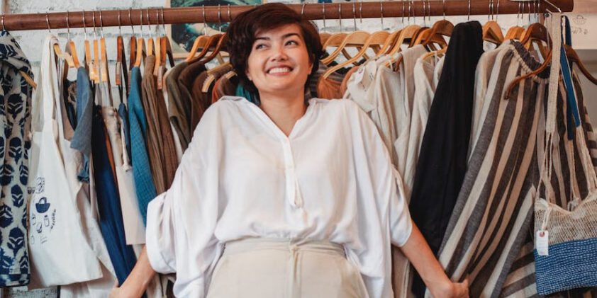 woman-clothes-rack-smiling-shopping woman clothes rack shopping retail